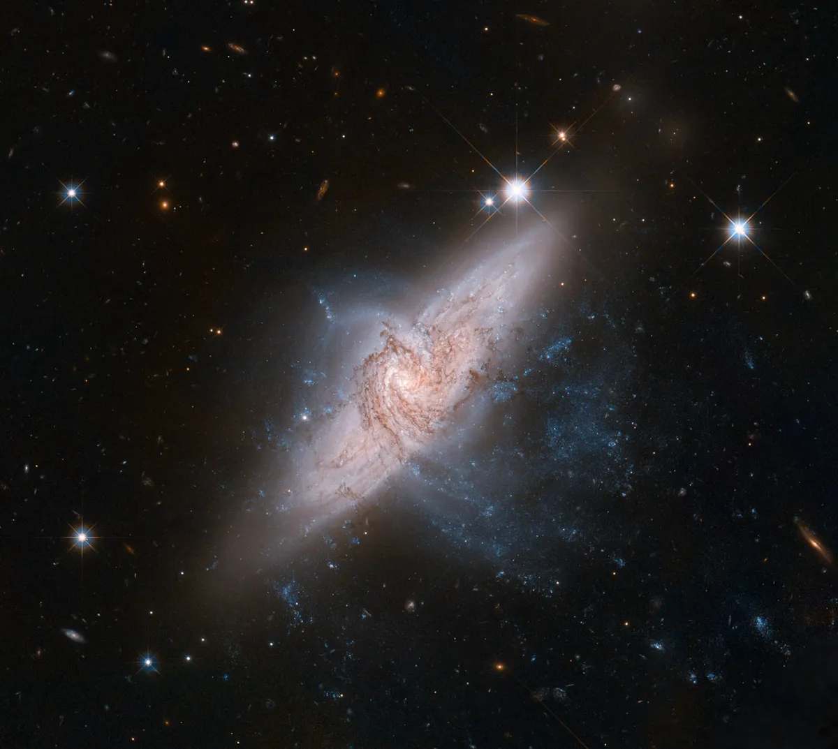 NGC 3314 14 June 2012. A pair of ‘overlapping’ galaxies called NGC 3314. While they appear to be colliding, they are only in alignment from our vantage point. Credit: NASA, ESA, the Hubble Heritage (STScI/AURA)-ESA/Hubble Collaboration, and W. Keel (University of Alabama)