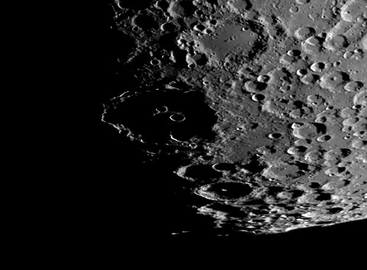 The Eyes of Clavius are illuminated by sunlight on the rims of two craterlets. Credit: Steve Marsh