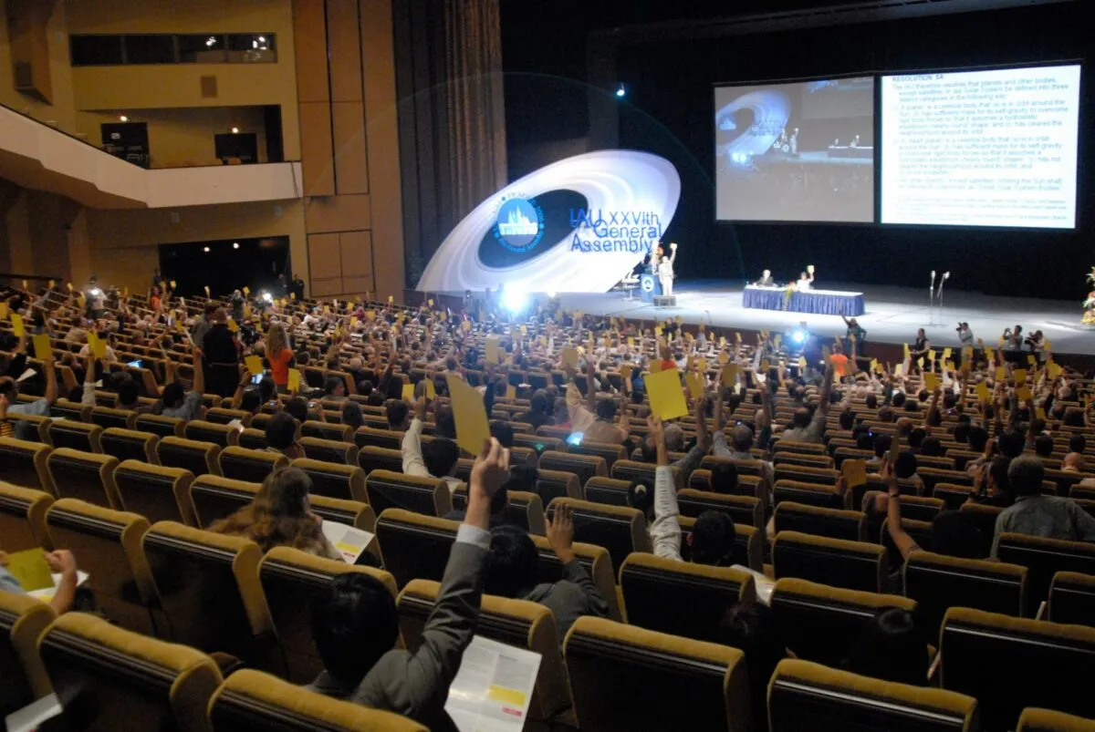 IAU members cast their votes at the 2006 General Assembly, and Pluto's fate is sealed. Credit: IAU/Robert Hurt (SSC)