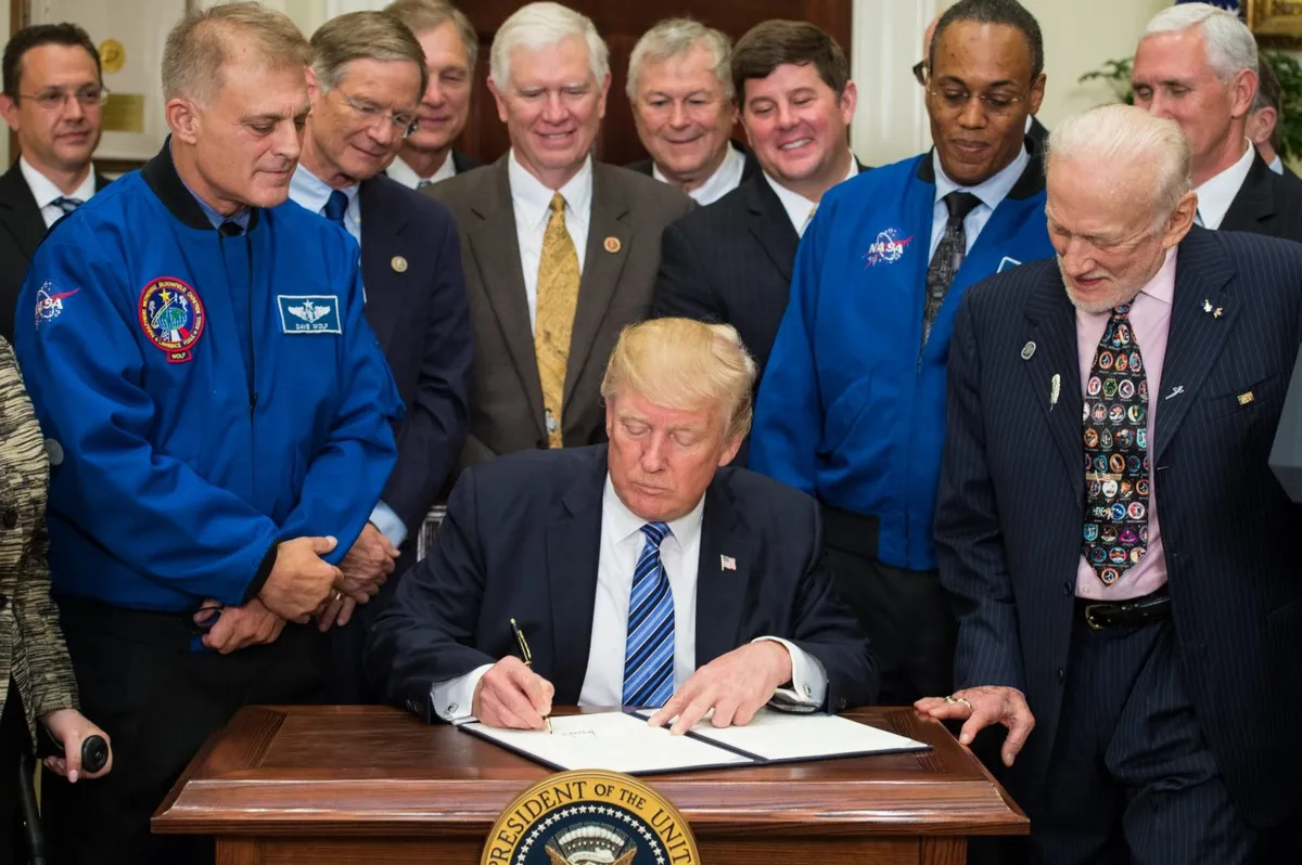 Buzz Aldrin (right) looks on as US President Donald Trump signs an Executive Order to reestablish the National Space Council, 30 June 2017. Credit: NASA