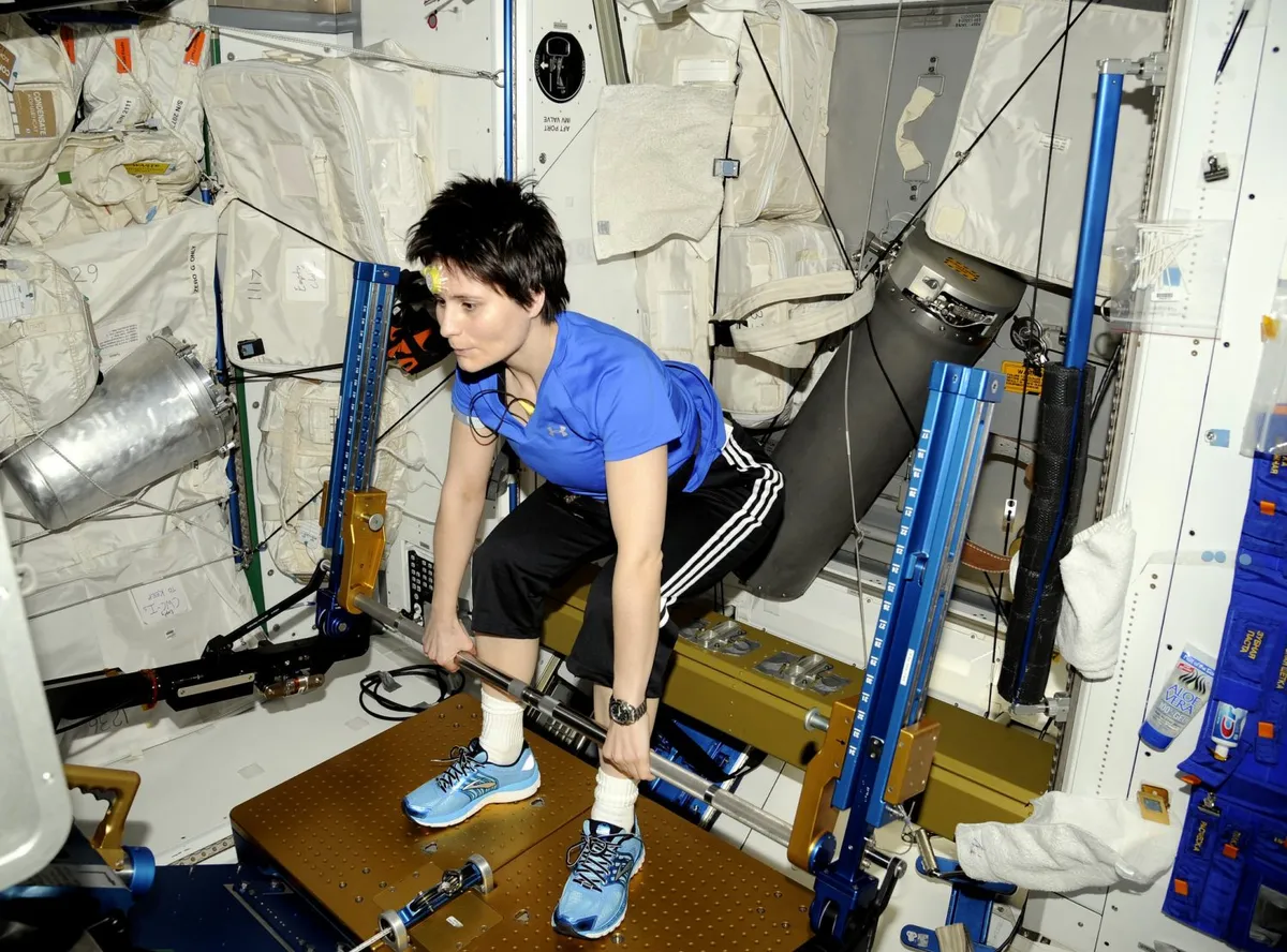 ESA astronaut Samantha Cristoforetti using the Advanced Resistive Exercise Device on the International Space Station, which hels astronauts strengthen muscles in zero gravity. Credit: NASA/ESA