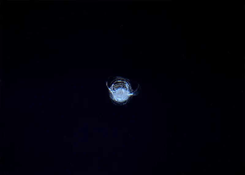 Image showing a 7mm-diameter chip in the Cupola window on the International Space Station, gouged out by the impact from a piece of space debris. The image was captured by astronaut Tim Peake. Credit: NASA/ESA