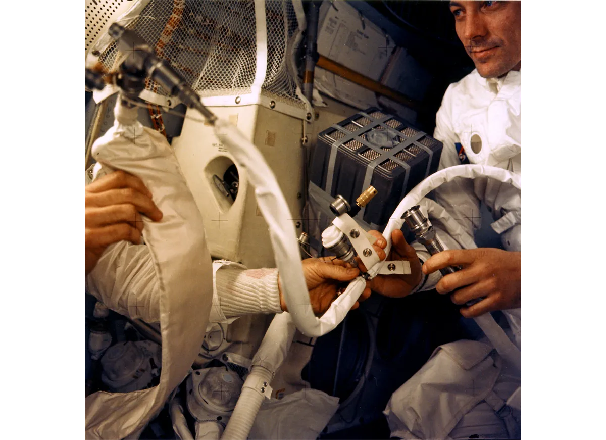 To prevent carbon-dioxide poisoning, the Apollo 13 crew worked on a filter in the lunar module. Jack Swigert is on the right. Credit: NASA