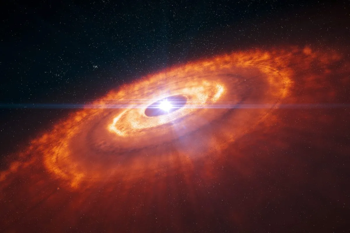 Artist’s impression of a young star surrounded by a protoplanetary disc. Our Solar System may have looked like this in its infancy. Credit: ESO/L. Calçada