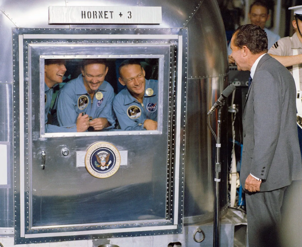 US President Nixon greets the Apollo 11 astronauts during quarantine on the recovery ship USS Hornet. Credit: NASA