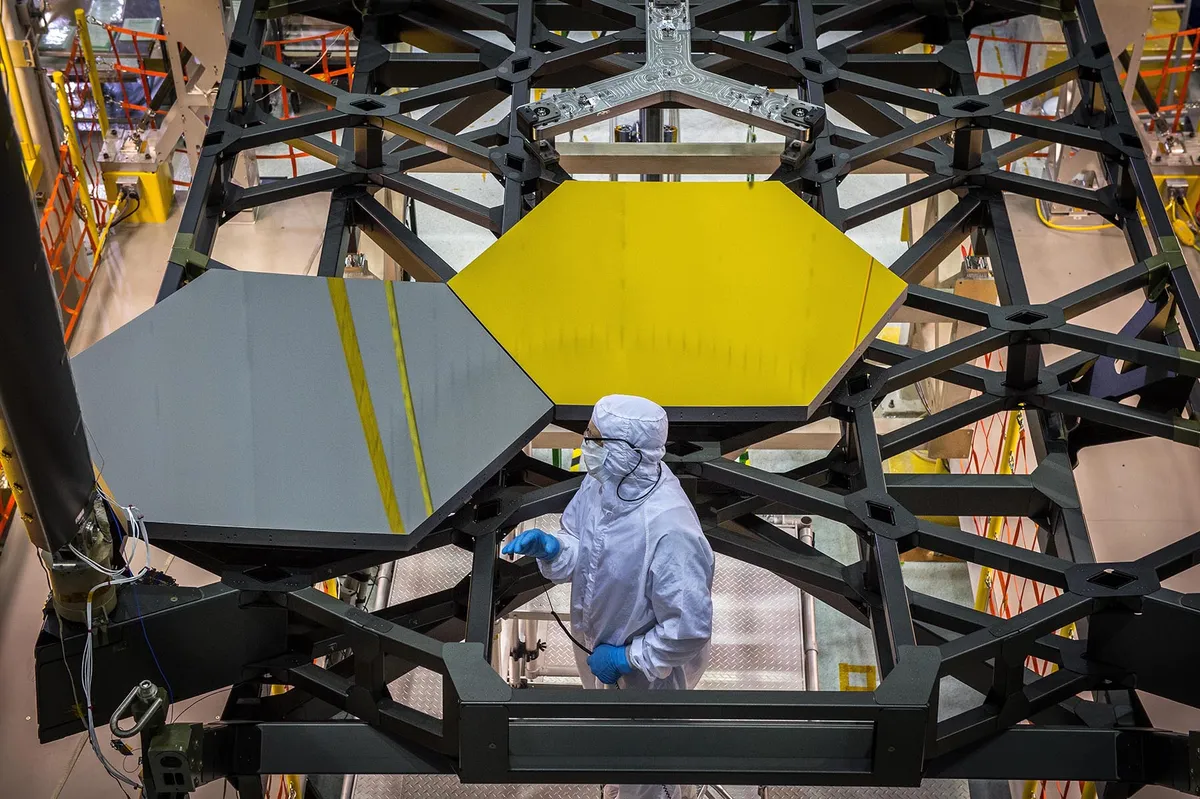 Two JWST primary mirror segments are slotted onto their support structure. Credit: NASA/Chris Gunn