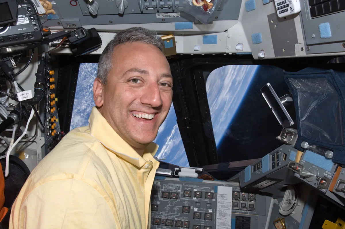 Astronaut Mike Massimino at the commander's station on Space Shuttle Atlantis. Credit: NASA