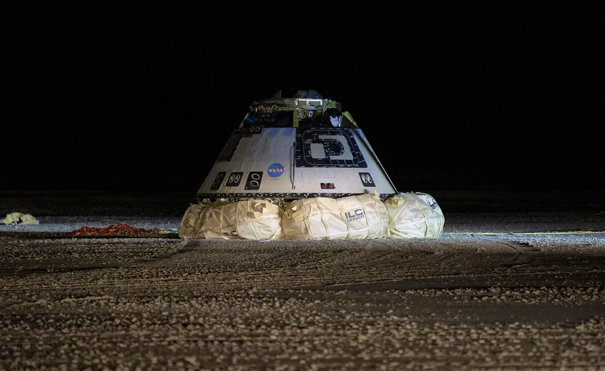 Boeing's CST-100 Starliner spacecraft pictured following its successful landing in White Sands, New Mexico, 22 December 2019. The spacecraft had just completed an orbital flight test as part of operations for NASA's Commercial Crew program. Photo by Bill Ingalls/NASA via Getty Images