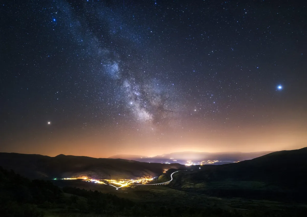 A view of the Milky Way over Gran Sasso, Italy. The bright red 'star' on the left is Mars, while Saturn is at the middle of the image. The bright 'star' on the right is Jupiter. Credit: Dneutral Han / Getty Images
