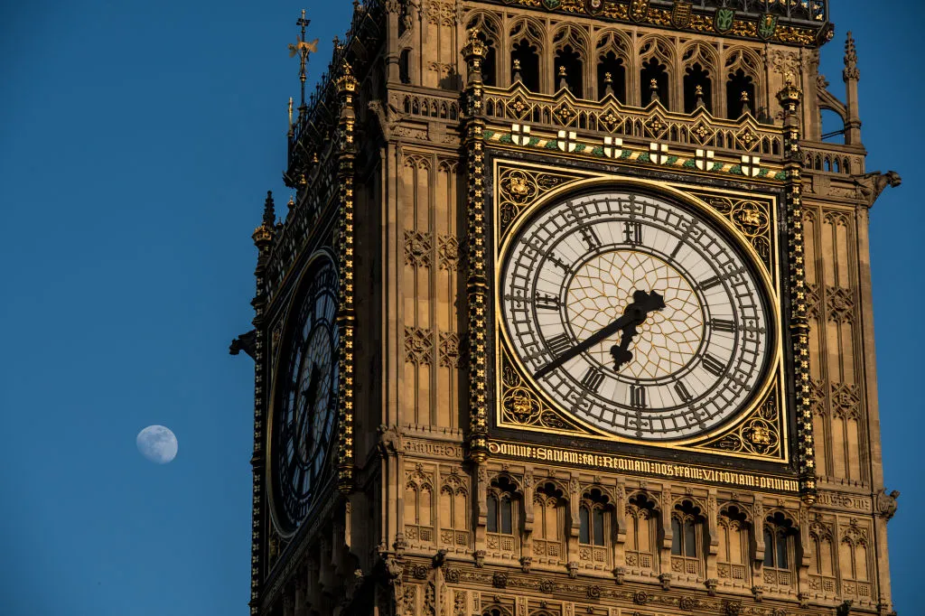 The Moon appears next to Big Ben on a clear sunny day in London, 7 April 2017. Photo by Chris J Ratcliffe/Getty Images