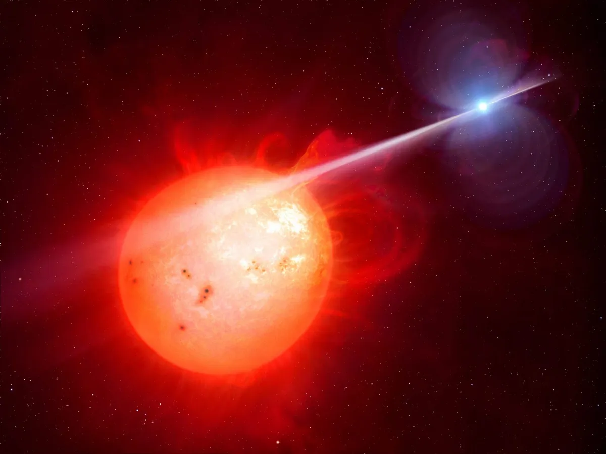 Artist’s impression of a red dwarf star (left) being blasted with radiation from a spinning white dwarf star (right). Credit: M. Garlick/University of Warwick/ESO