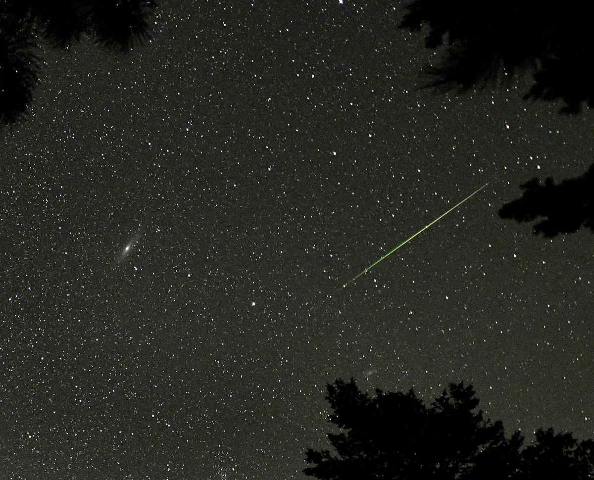A Perseid meteor seen near the Andromeda Galaxy (the bright smudge on the left of the image), Rocky Mountain National Park, Colorado, US, 12 August 2018. Credit: STAN HONDA/AFP via Getty Images