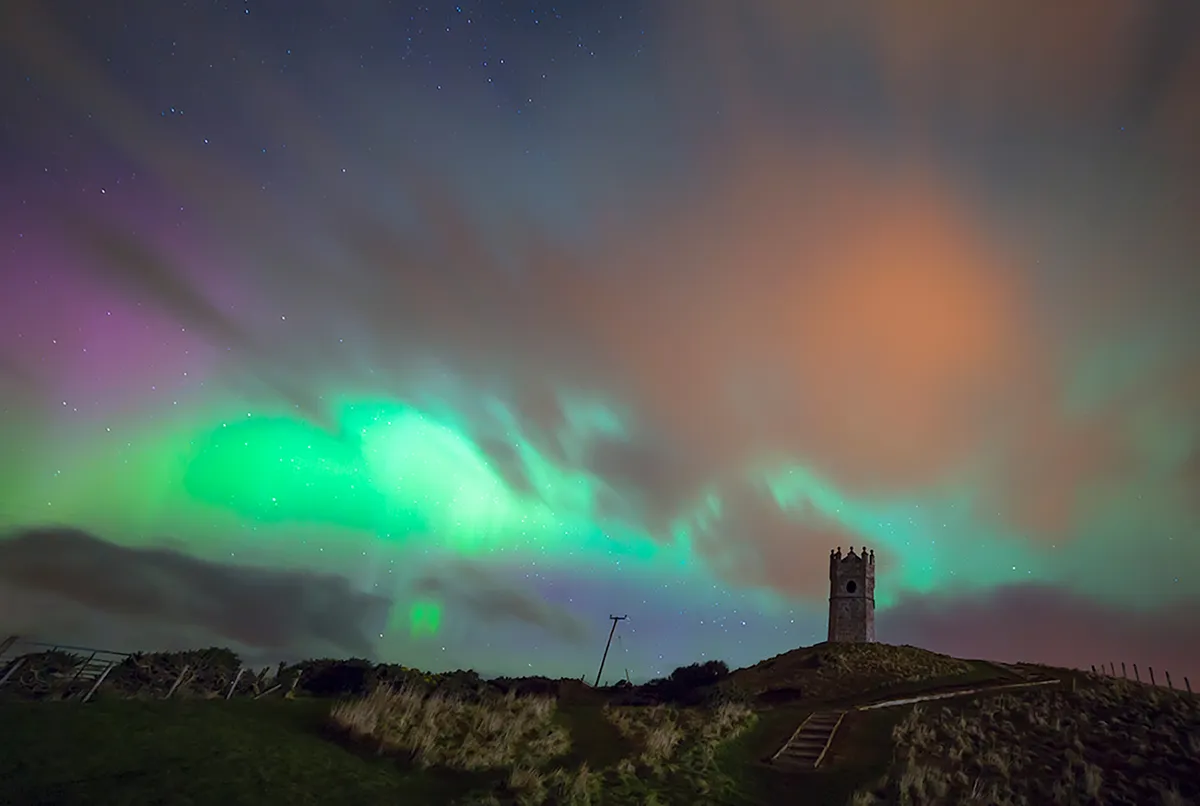 The northern lights over a Scottish castle