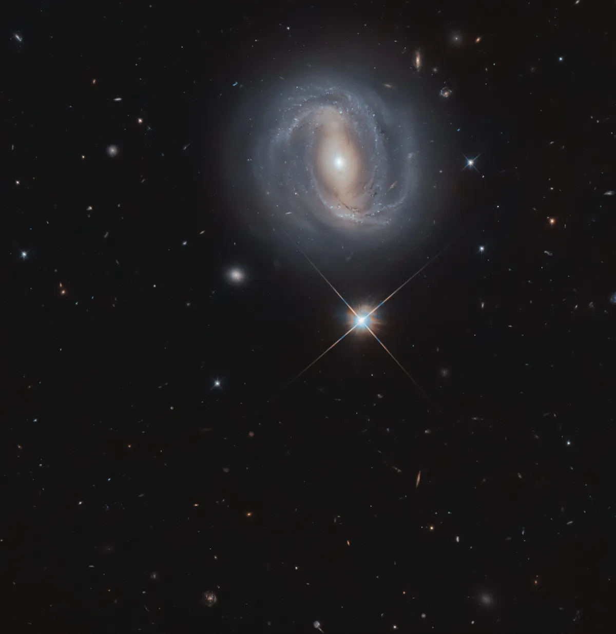 Barred spiral galaxy NGC 4907 and a Milky Way star. Credit ESA/Hubble & NASA, M. Gregg