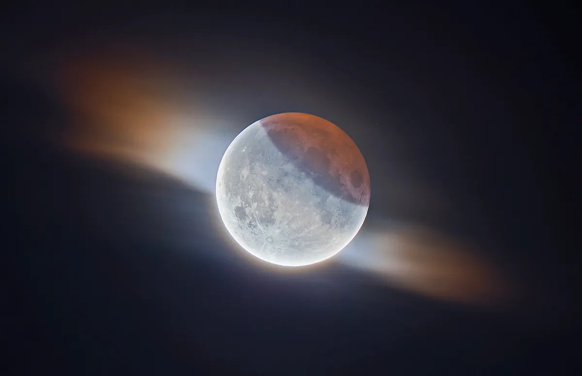 HDR Partial Lunar Eclipse with Clouds Ethan Roberts (UK). Runner up, Our Moon. Equipment: Sky-Watcher Evostar 80ED, Sky-Watcher EQ5 SynScan mount, Canon EOS 100D camera.