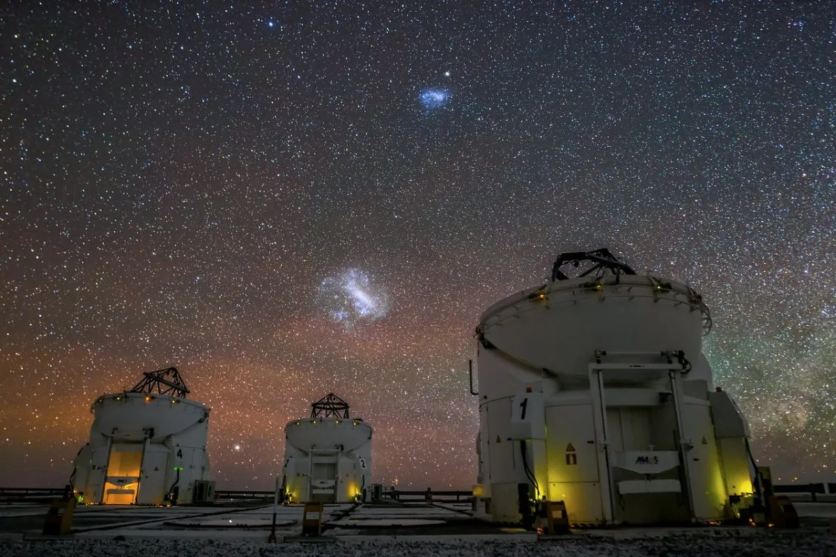 The Large and Small Magellanic Clouds appear over the Very Large Telescope in the night sky above Chile. Credit: J. C. Muñoz/ESO