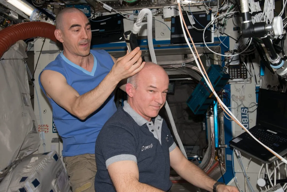 Have you ever wondered how astronauts get their hair cut in space? Here, Russian cosmonaut Anatoly Ivanishin uses a specially-designed razor to trim Jeff Williams’ hair. The razor includes a vacuum hose to suck up hair follicles and prevent them floating away. Credit: NASA