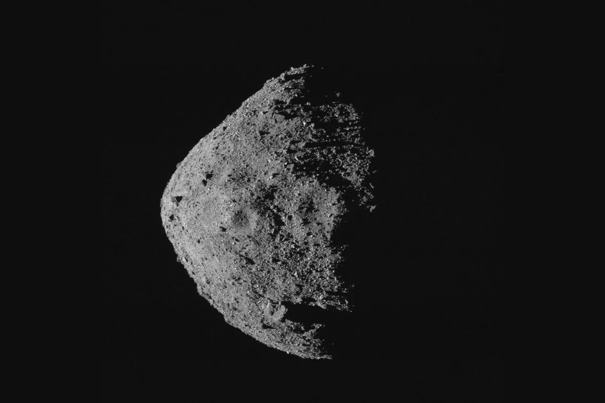 A view of asteroid Bennu, its striking craters and surface covered in boulders, captured by OSIRIS-REx's OCAMS (MapCam) instrument on 28 April 2020 from a distance of 10km. Half of Bennu is bathed in sunlight, and half is in shadow. Credit: NASA/Goddard/University of Arizona