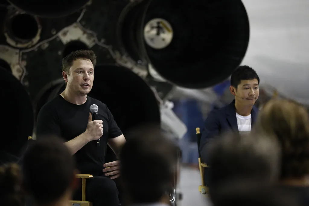 SpaceX CEO Elon Musk pictured with Yusaku Maezawa, September 2018, as the pair reveal their plans to send passengers on a flight around the Moon. Credit: Patrick T. Fallon/Bloomberg via Getty Images