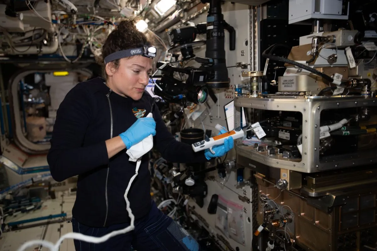 NASA astronaut Jessica Meir working on the Advanced Colloids Experiment-Temperature-4 (ACE-T-4) on the ISS, which examines how different particles form 3D crystals under various conditions. The experiment could have implications for 3D printing. Credit: NASA