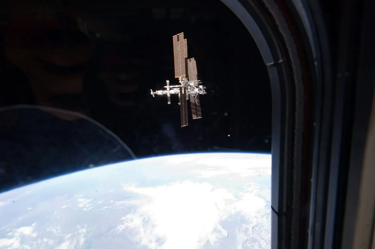 The construction of the ISS was undoubtedly one of the Shuttle’s biggest achievements. Here, the Space Station is seen orbiting Earth through the window of Space Shuttle Atlantis, 19 July 2011. Credit: NASA