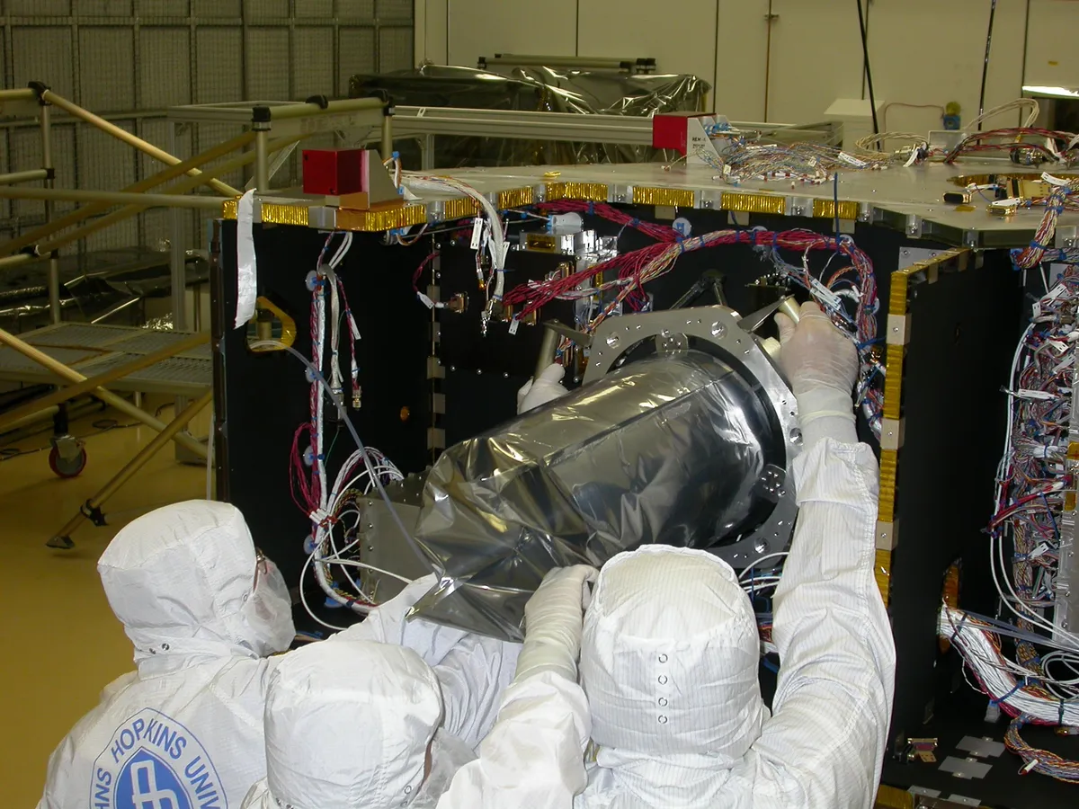 Technicians at Johns Hopkins University Applied Physics Laboratory install the LORRI camera on New Horizons ahead of its launch in January 206. Credit: NASA