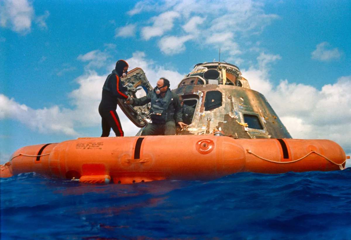 Edgar Mitchell is assisted out of the Command Module (CM) by a U.S. Navy swimmer during the Apollo 14's recovery in the South Pacific Ocean. Credit: NASA