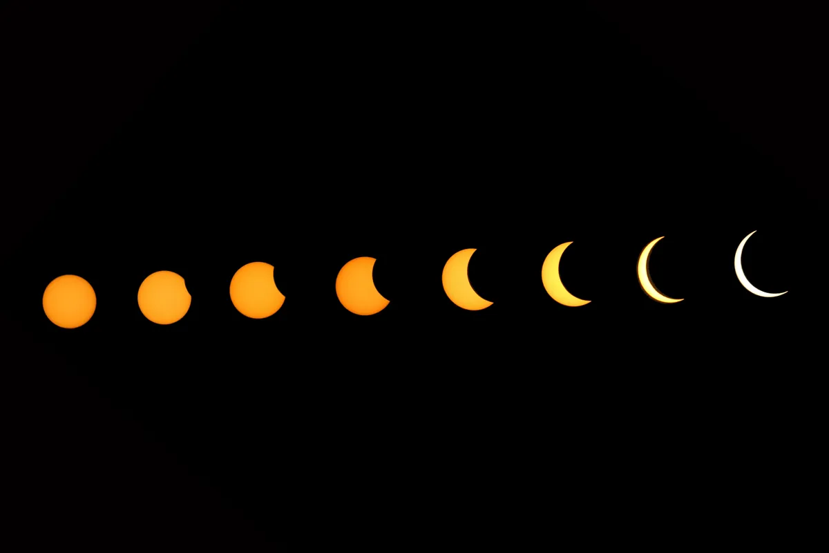A composite images showing the stages of a solar eclipse. Photo by Vishal Bhatnagar/NurPhoto via Getty Images)