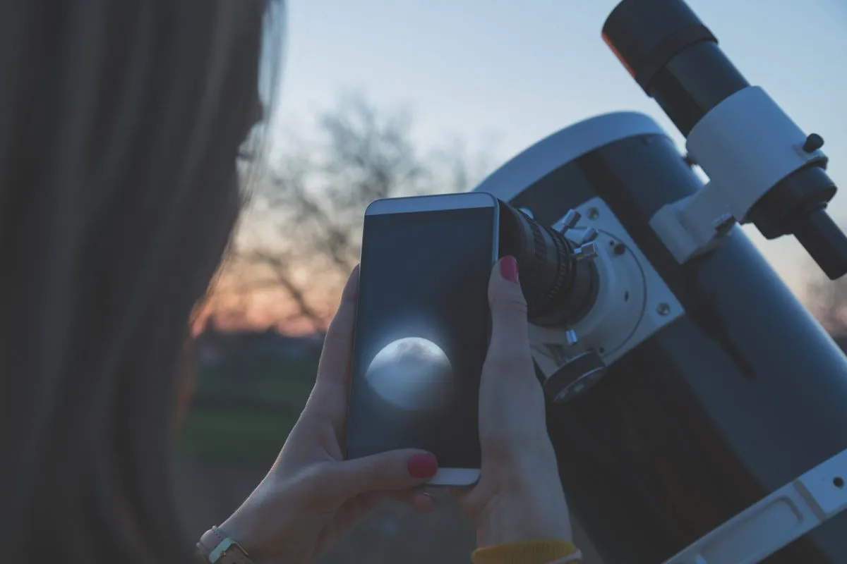 Smartphone astrophotography gadgets help you achieve such wondrous feats as photographing the Moon through a telescope.  Credit: m-gucci / Getty Images