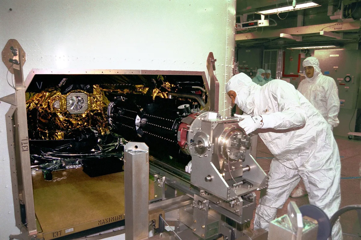 NASA scientists installing 1 of 3 Radioisotope Thermoelectric Generators (RTGs) on the Cassini spacecraft. Credit: NASA/JPL-Caltech