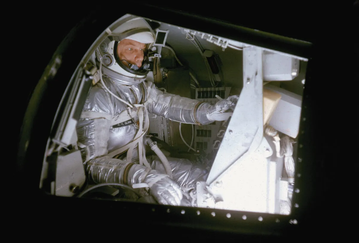Mercury 7 astronaut John Glenn pictured in a mock-up of the cramped Project Mercury space capsule, during training at Langley Research Center, Virginia, 1959. Credit: Ralph Morse/The LIFE Picture Collection via Getty Images