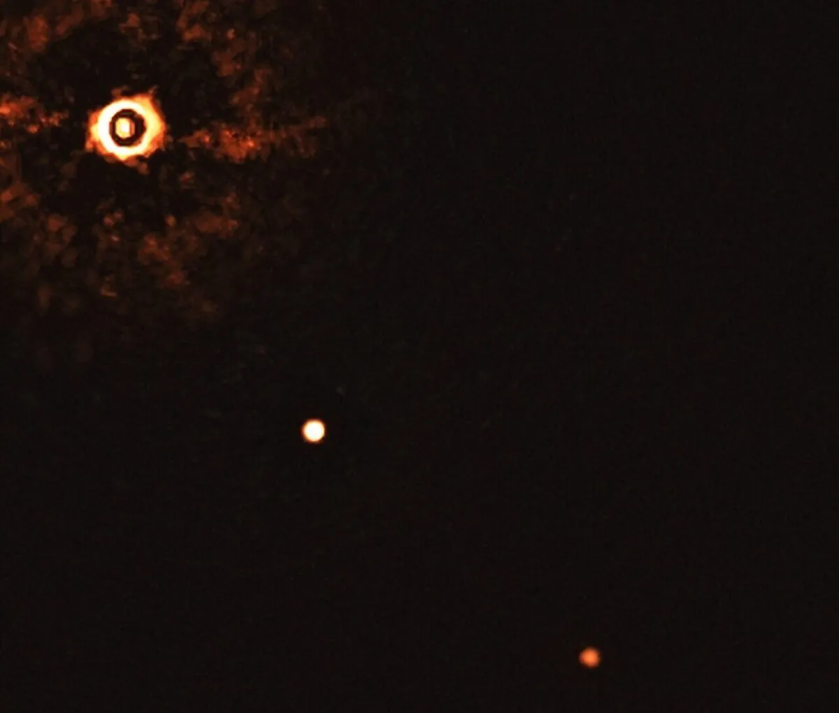 A direct image of 2 exoplanets orbiting a Sun-like star. The planets are TYC 8998-760-1 b and c, and can be seen middle and lower right. Credit: ESO/Bohn et al.