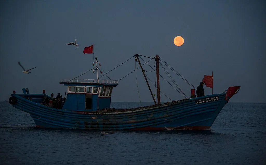 A fishing boat sails under a full Moon in Xianrendao in China's northeastern Liaoning province 17 September 2016. Credit: JOHANNES EISELE/AFP via Getty Images)
