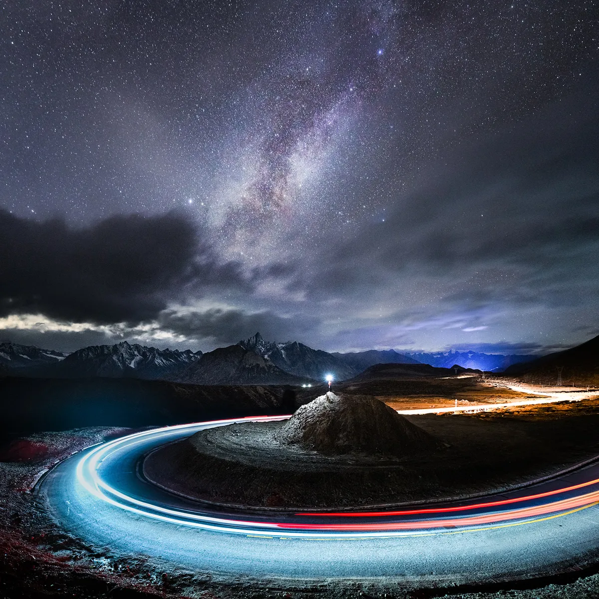 Star Watcher © Yang Sutie (China), Ranwu, Tibet, China, 22 October 2020. Equipment: Nikon Z 7II camera, 17 mm f/2.8 lens. Car lights and figure: ISO 1000, 2 x 25-second exposures. Sky and mountains: ISO 6400, 25-second exposure