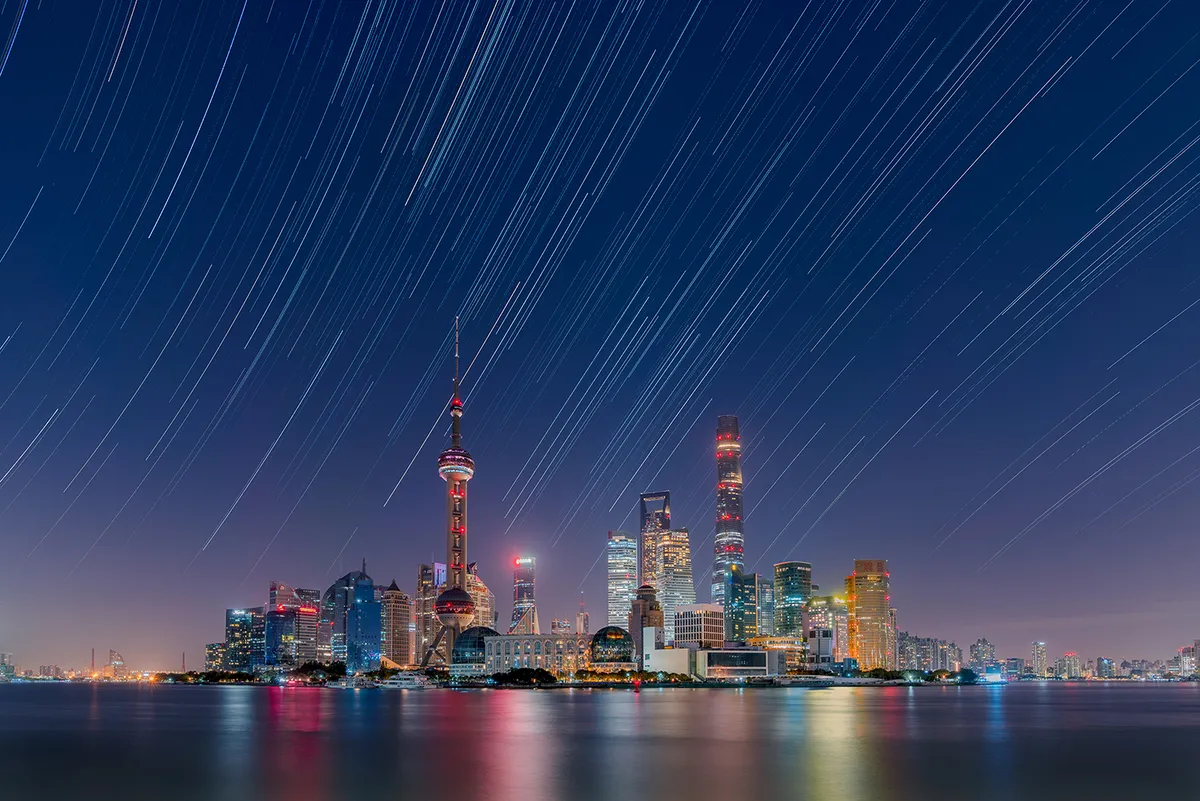 Star trails over the Lujiazui City Skyline © Daning Kai (China), Shanghai, East China, China, 13 October 2020. Equipment: Sony ILCE-7RM3 camera, 16 mm f/5.6 lens, ISO 100, 305 x 15-second exposures