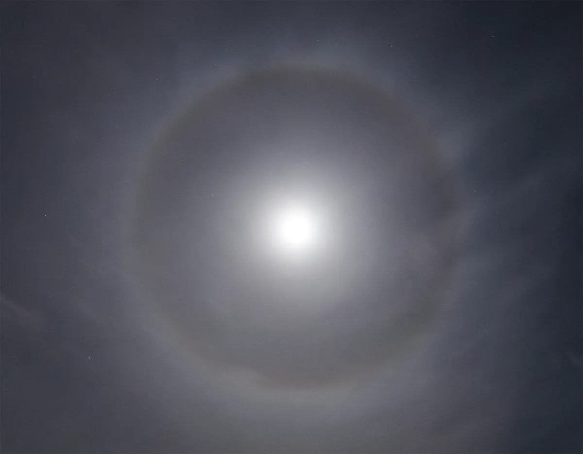 Moonlight shining through ice crystals in clouds may result in the 22° lunar halo. Credit: Will Gater.