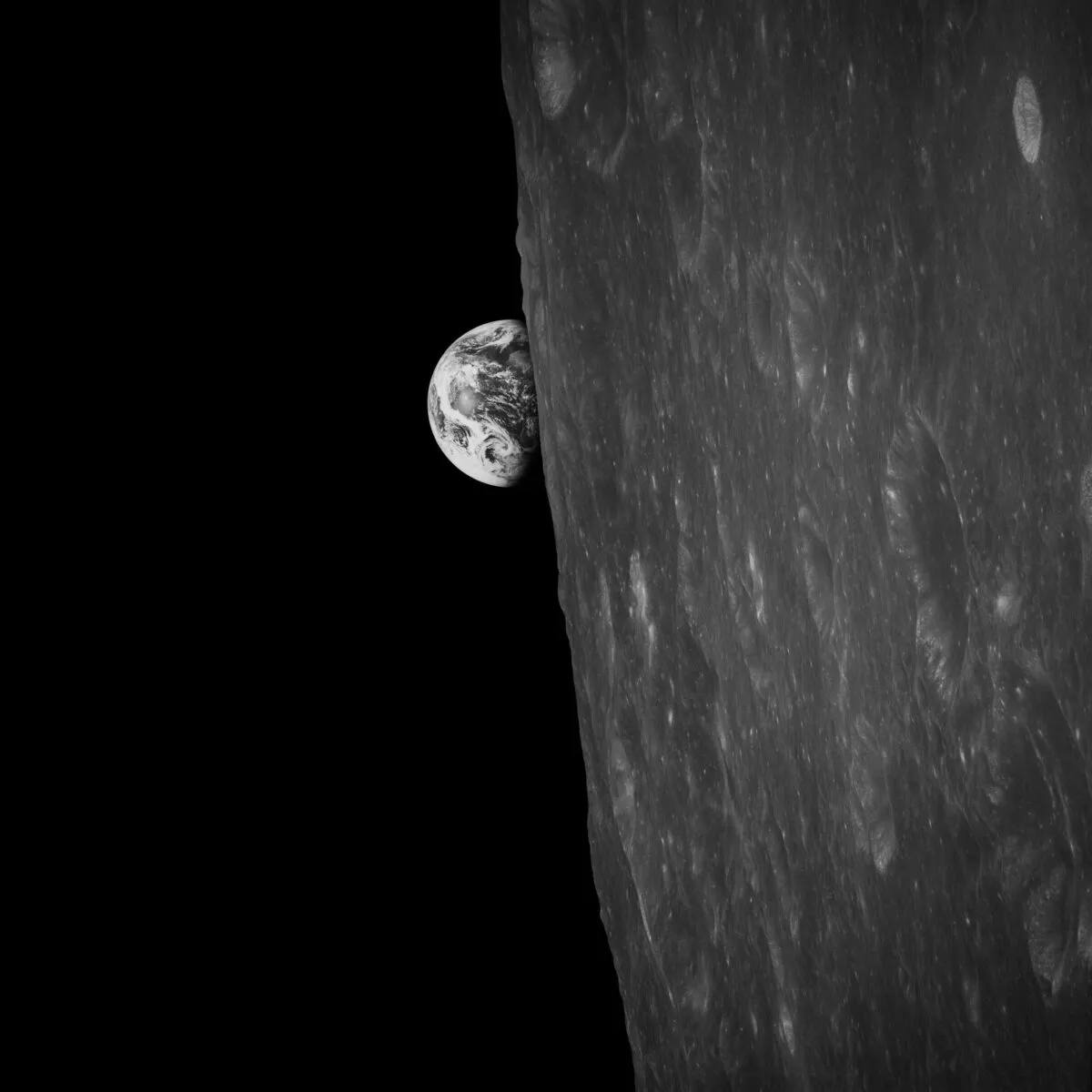 The first earthrise photo, captured by Apollo 8 astronaut Bill Anders moments before his more famous colour shot, 24 December 1968. Credit: NASA / restored by Toby Ord