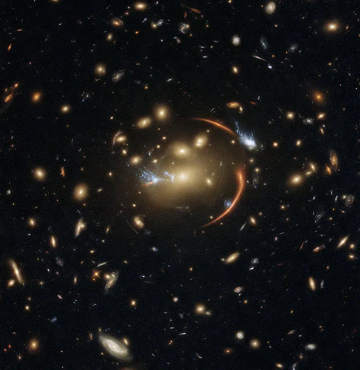 Gravitational lensing caused by foreground galaxy cluster MACSJ0138.0-2155 brings far-distant galaxy MRG-M0138 into view, HUBBLE SPACE TELESCOPE, 19 JULY 2021. IMAGE CREDIT: ESA/Hubble & NASA, A. Newman, M. Akhshik, K. Whitaker