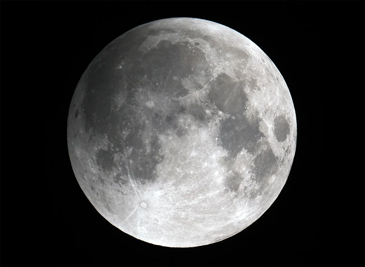 A photo of a penumbral lunar eclipse with the northwest edge of the Moon starting to darken.