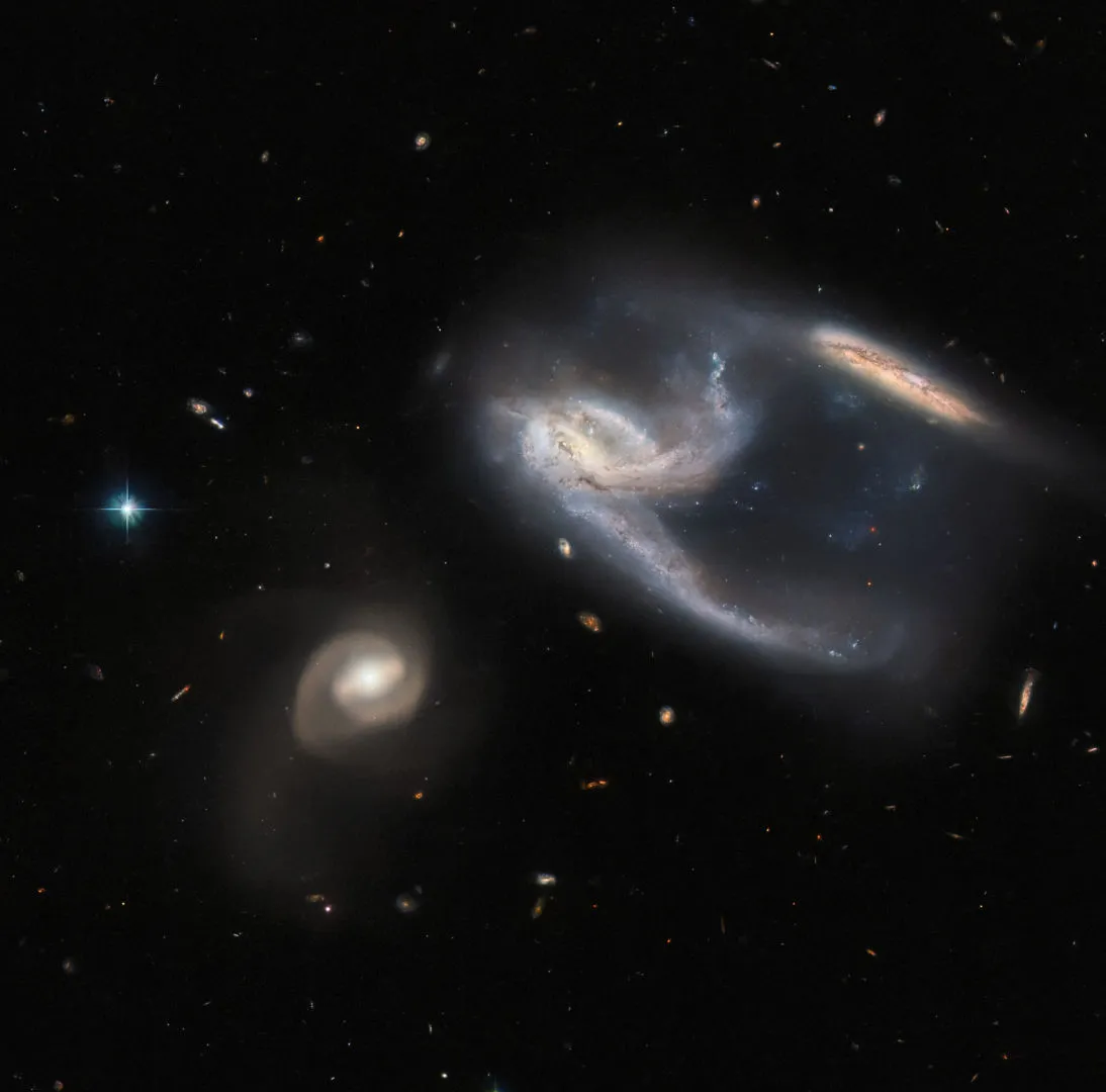Galaxy triplet NGC 7764A in the constellation Phoenix HUBBLE SPACE TELESCOPE, 24 JANUARY 2022 IMAGE CREDIT: ESA/Hubble & NASA, J. Dalcanton, Dark Energy Survey, DOE, FNAL, DECam, CTIO, NOIRLab/NSF/AURA, ESO. Acknowledgement: J. Schmidt