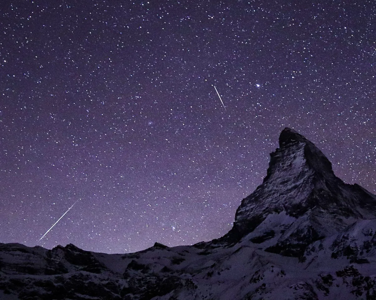 No winter astronomy list would be complete without the Geminid meteor shower. Credit: Meena Singelee, Schwartzsee, Zermatt, Switzerland, 13 December 2021
