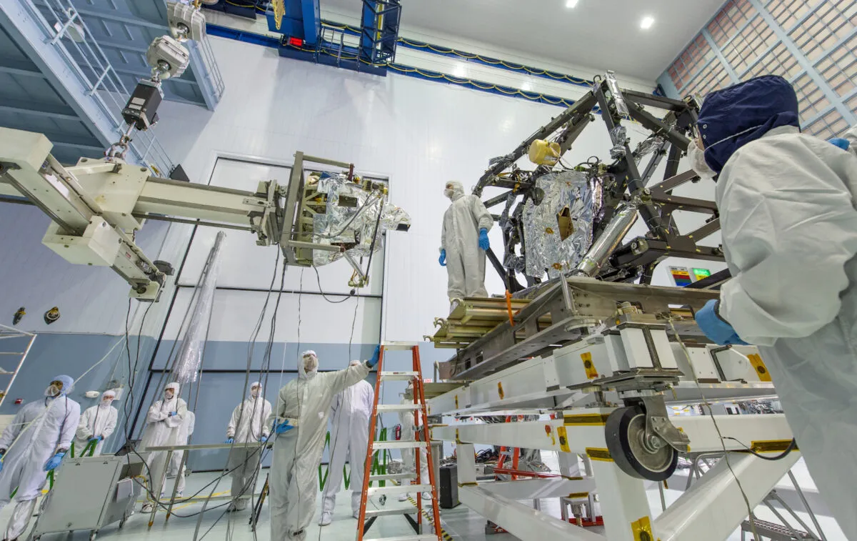 MIRI (left) being integrated into JWST’s science payload module at NASA’s Goddard Space Flight Center in 2013. Credit: NASA/C. Gunn