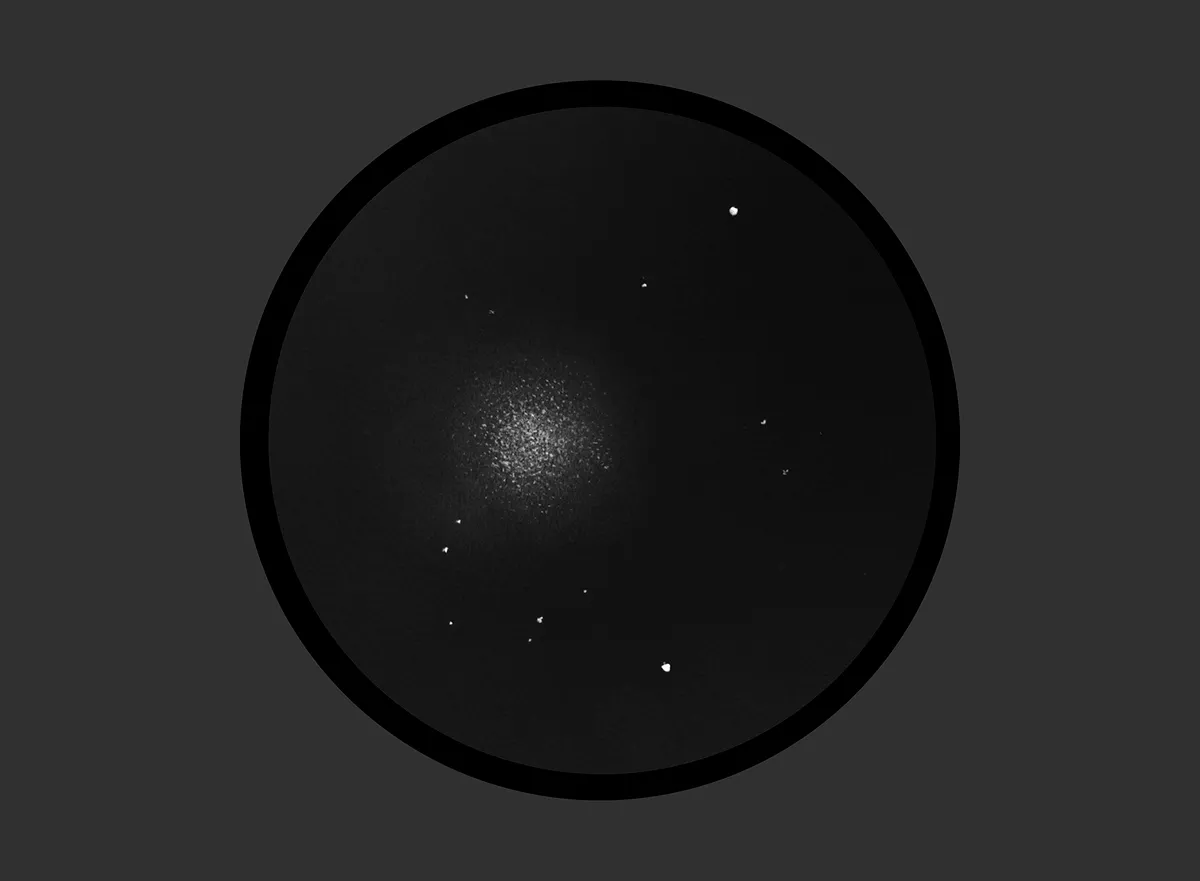 Illustration showing the view of M13 through a small telescope’s eyepiece. Credit: Will Gater