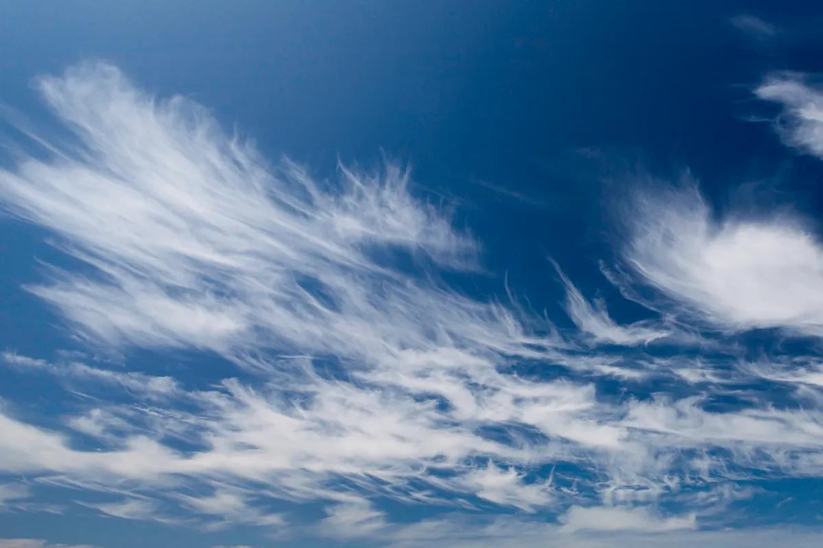 Cirrus clouds are found at high altitudes and resemble tufts of hair or cotton wool. Credit: Doug Armand / Getty Images