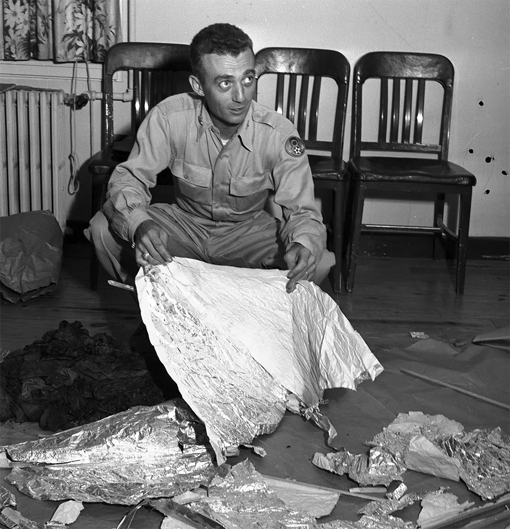 At Fort Worth Army Air Field, Major Jesse A. Marcel holds foil debris from Roswell, New Mexico during the so-called UFO incident. Courtesy, Fort Worth Star-Telegram Photograph Collection, Special Collections, The University of Texas at Arlington Library, Arlington, Texas
