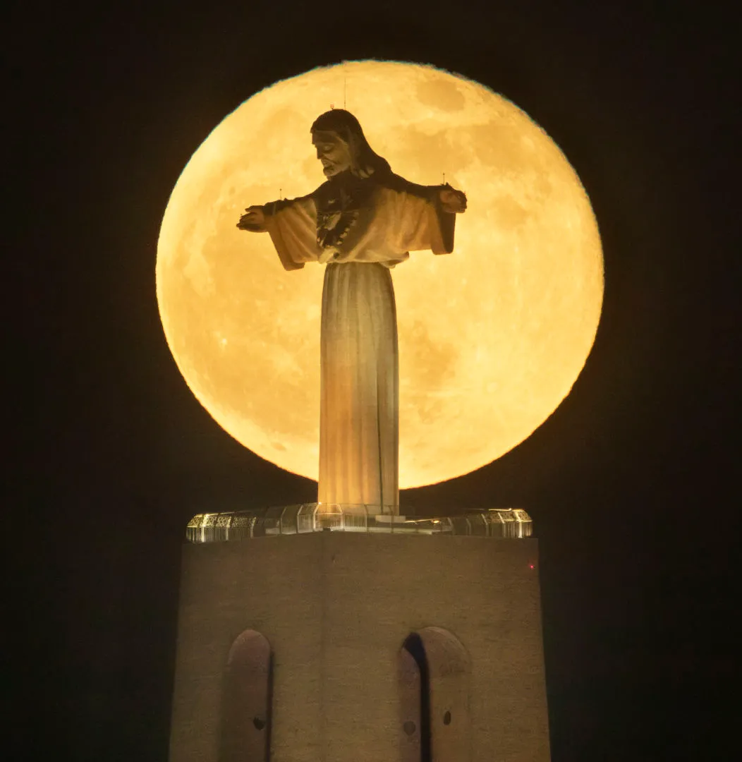 Flower Moon rising over Christ the King Mara Leite, Almada, Lisbon, 16 May 2022 Equipment: Canon 5D Mark IV DSLR, Sigma 70–200mm lens with 2x extender, Manfrotto 190Go! tripod