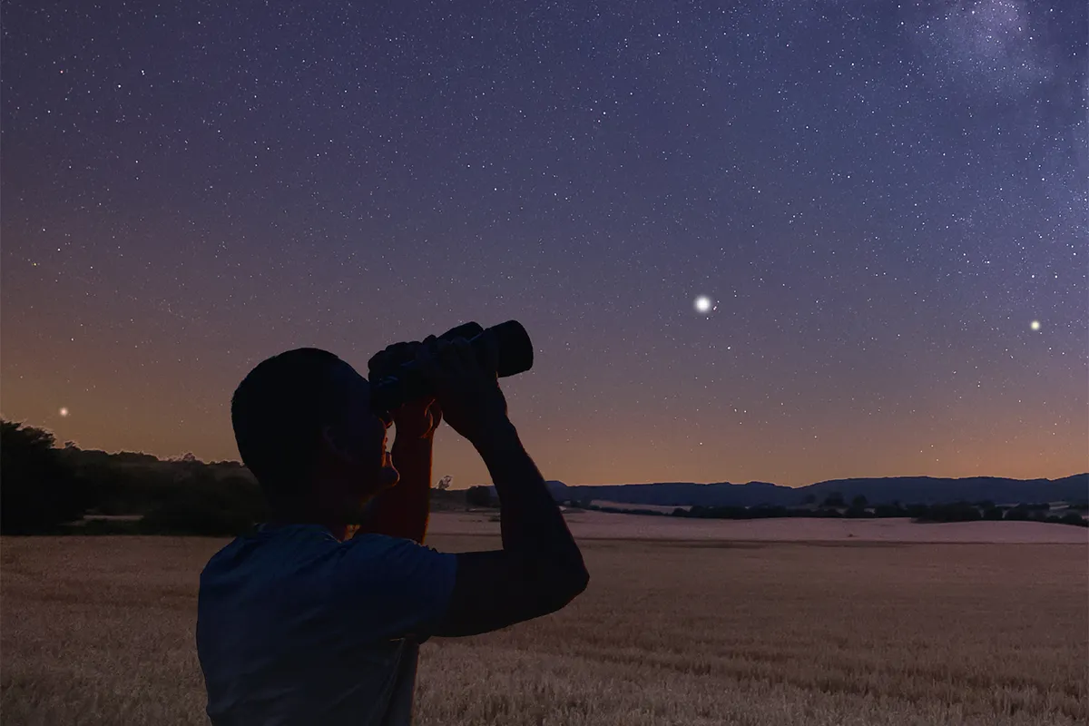 See Jupiter, Saturn, Uranus and Neptune in the night sky during the December planet parade. Even a pair of binoculars will help you enjoy the planets. Credit: ARUIZHU/istock/getty images