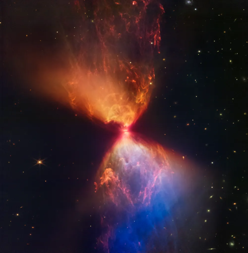 An image of protostar L1527 at the centre of billowing clouds of cosmic gas and dust, captured by the James Webb Space Telescope.