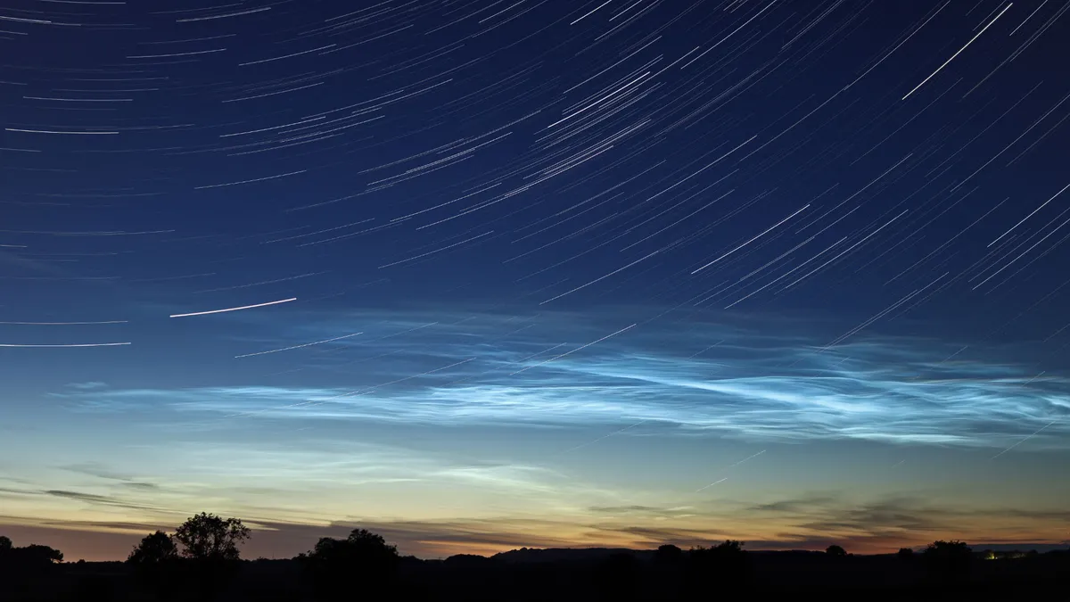 Star trails and noctilucent clouds, Steven Brown, Stokesley, North Yorkshire, 21 June 2022 Equipment: Canon EOS 250D DSLR camera, Canon EF-S 24mm lens at f/2.8, Camlink TP-2800 tripod