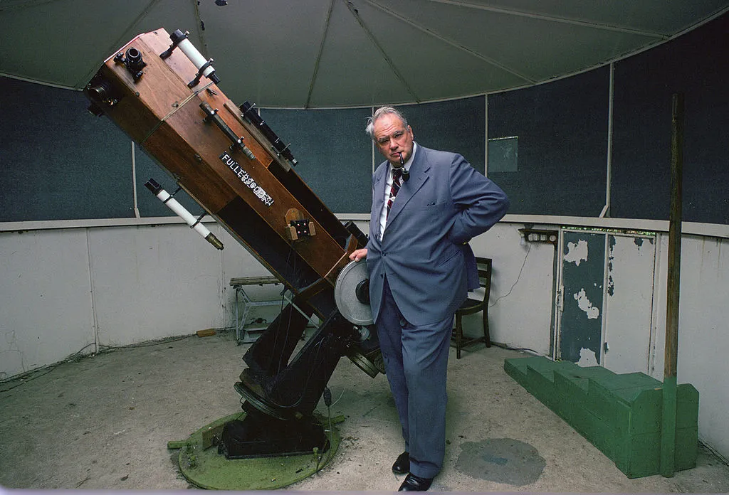 Patrick Moore with his telescope in his own observatory at home in Sussex. Photo by Tim Graham/Getty Images.